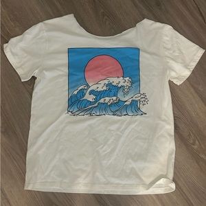 cream oversized one shoulder t-shirt with blue waves and pink sun